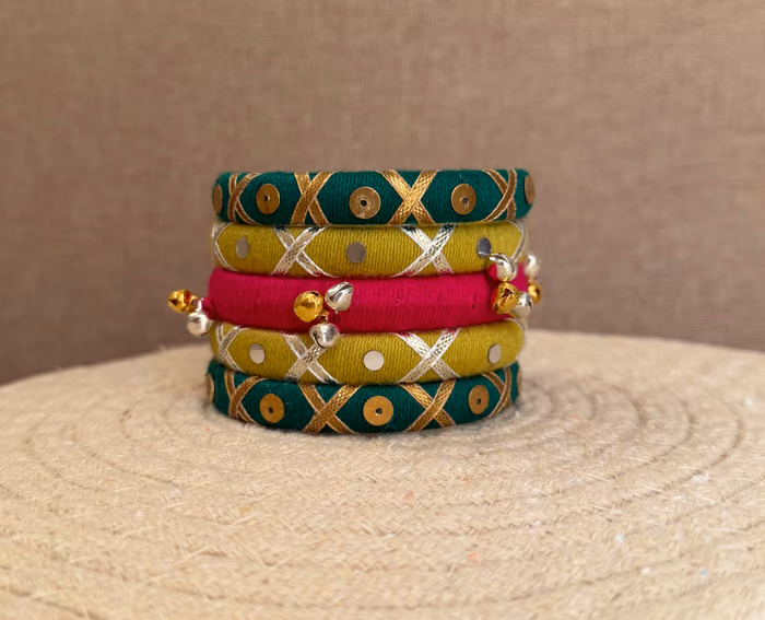 Raasika green yellow and pink handmade thread bangle set with metallic ghungroo by Kruki Dooki